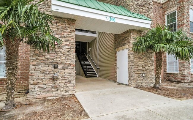Building Photo - Don't miss this 4-bed, 3-bath condo TWO miles from the ocean! Unit 300GC 325