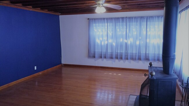 Large living room w hard wood floor and large storage closetwood floor and beamed ceiling. - 1946 Lincoln St House