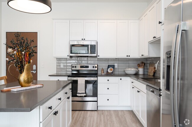 Modern kitchens are designed with sleek finishes and high-end appliances for a polished, functional space. - The Rowan Rental