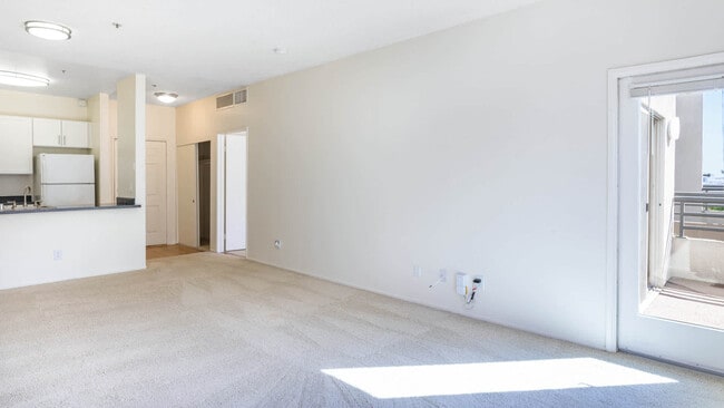 Carpeted Living Room with Balcony