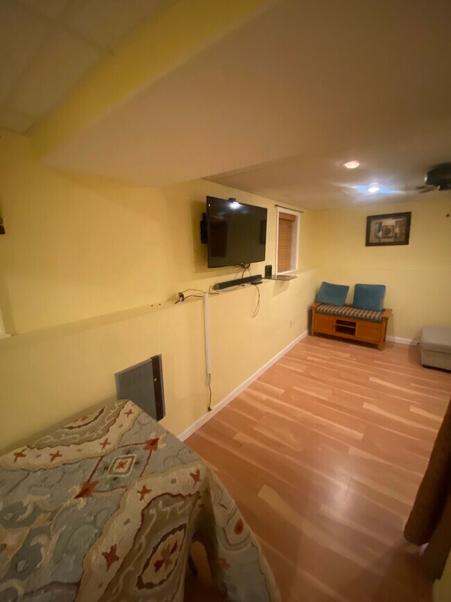 living space w/ provided furnishings , seater, and TV - 40 Castine St