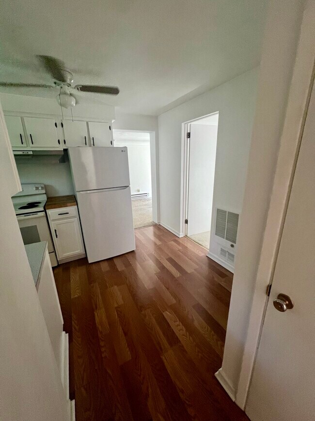 Kitchen hallway to living room and smaller bedroom - 2612 Louisiana Ave Unit 1