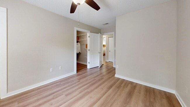 Unwind in the Jekyll master bedroom with elegant wood-styled floors and enjoy the vast walk-in closet adorned with customized shelving.
