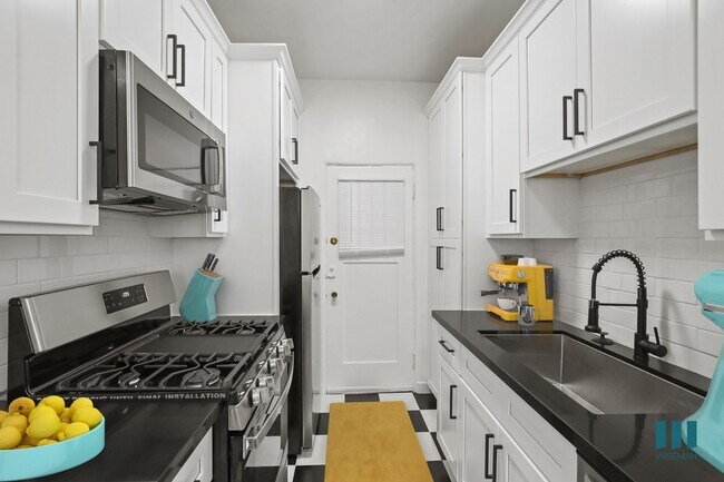 Kitchen with Stainless-Steel Refrigerator, Stove, Microwave Oven, and Dishwasher - Blackburn Grove by Wiseman