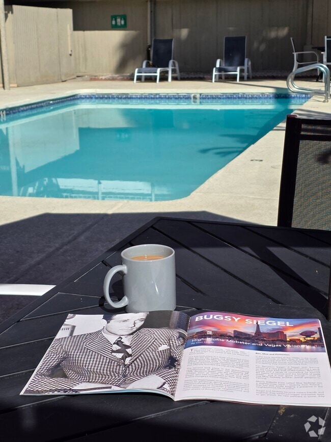 Poolside morning coffee and a good read - Studio 629 Rental