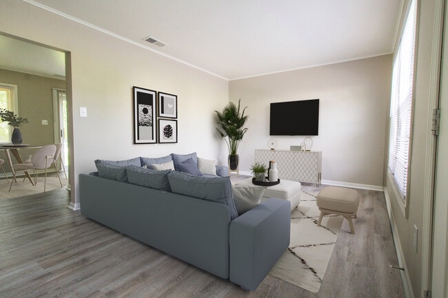 Sala de estar de pizarra con tablones de vinilo - Meadowfield Townhomes