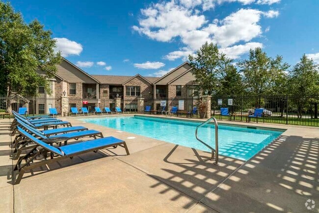 On a hot day, you'll love taking a dip in the pool and relaxing in the lounge chairs. - Stone Creek Villas Rental