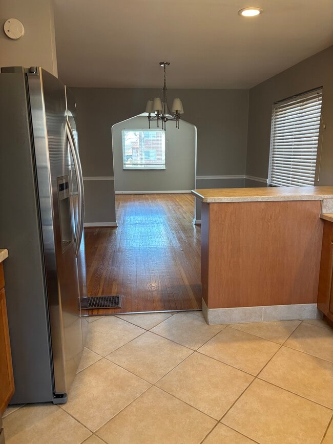 View from kitchen into dining and family areas - 3856 Belmont Street