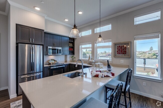 Lux Apartments offers spacious kitchens with dark walnut or arctic white cabinet finishes, stainless steel appliances, inset/undermount sinks, and quartz countertops - Lux Rental