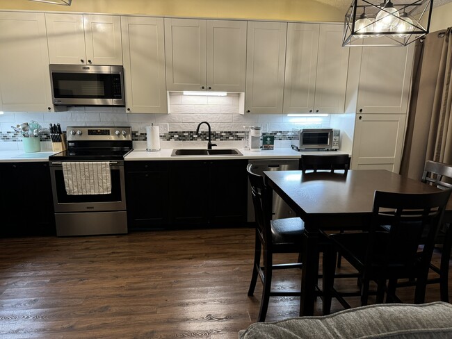 Large eat in kitchen with tons of cabinet storage - 4449 Charles St Condo Unit B