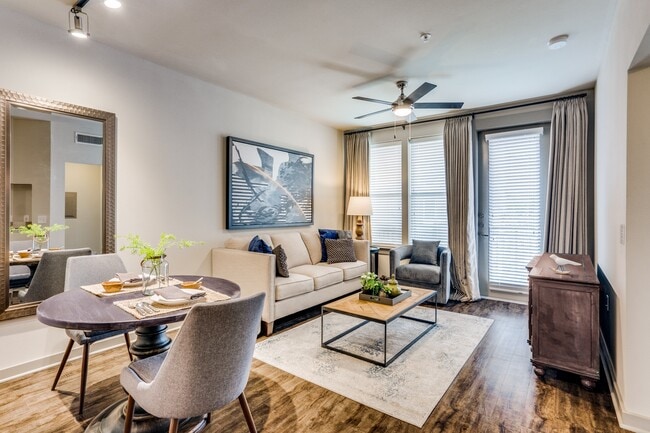 modern living room with wood plank flooring and natural lighting in Plano - Junction 15 Apartments