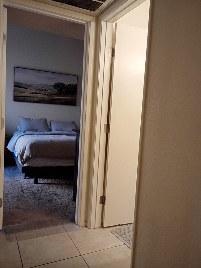 1st floor bedroom with first floor bath to the door on roght - 7618 E Callisto Cir Unit 122