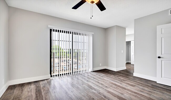 Spacious bedroom with natural lighting and wood flooring throughout