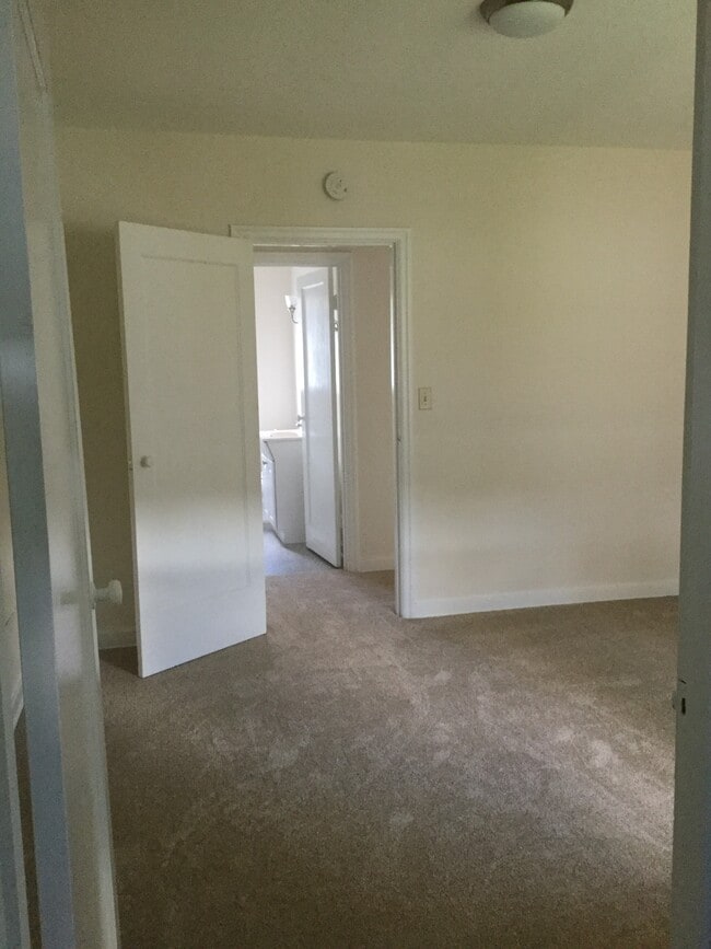 View from walk-in closet to bedroom door and bathroom beyond - 1008 E 2nd St