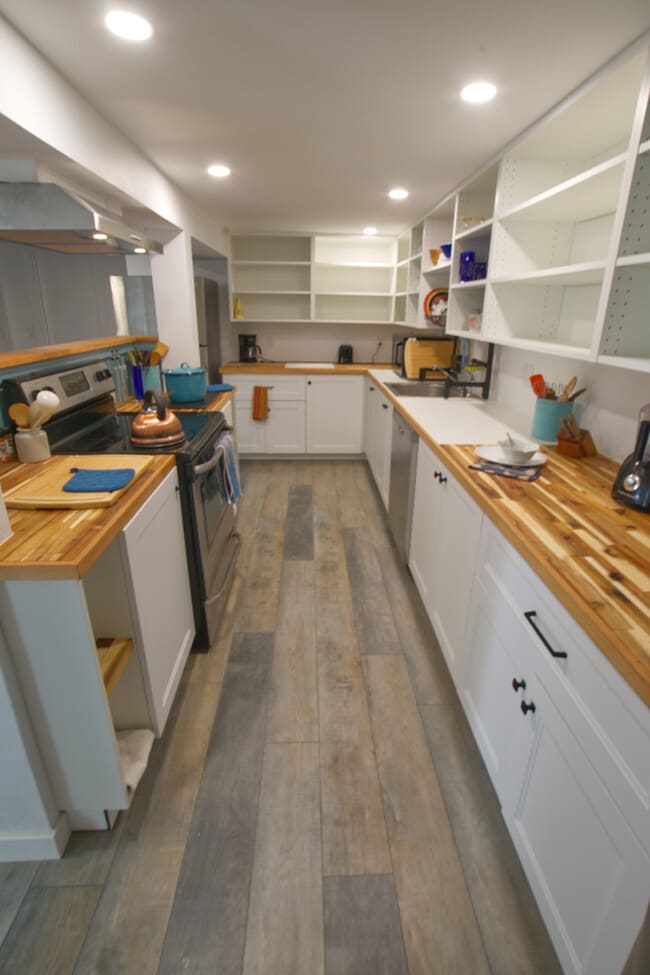 Kitchen counters are oiled butcher block and there's lots of open shelving for your pantry
