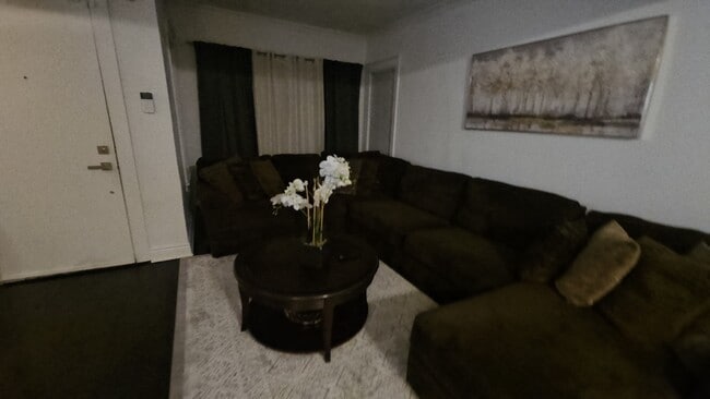 Spacious Living area with cozy couch and 70in smart tv - 7914 S Ridgeland Ave