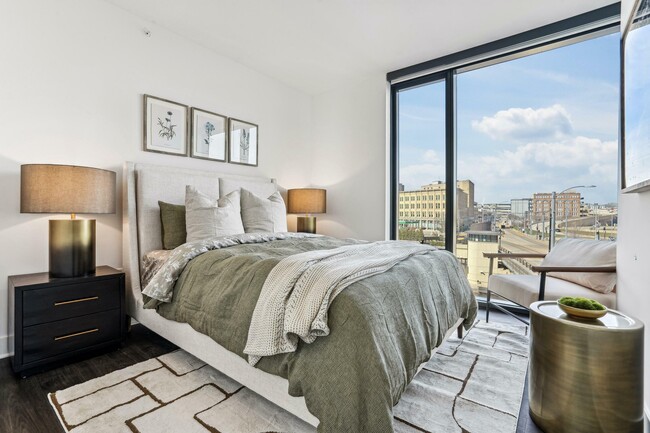 Rest in style — a fresh, modern bedroom with greenery, light, and thoughtful design touches.