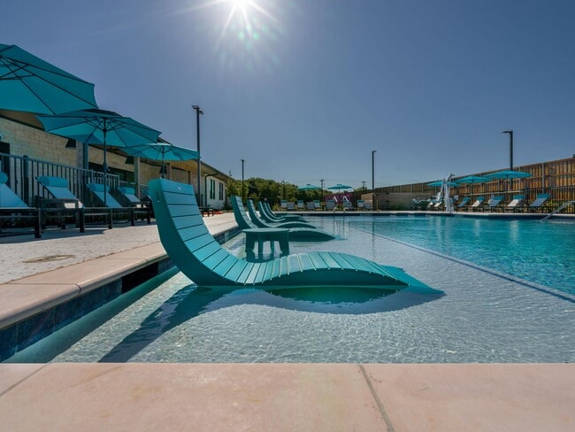 Resort-style swimming pool with lounge seating
