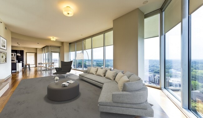 Spacious living room features floor-to-ceiling windows with amazing views of Buckhead