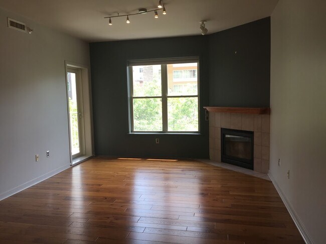 Unit is unfurnished with Large open living area with gas fireplace - 360 W Washington Ave Unit 305