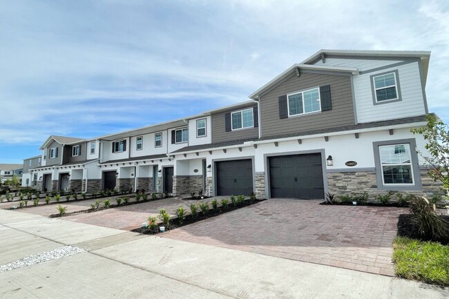 Fully landscaped with paver driveway - 14799 Outfitter St Townhome