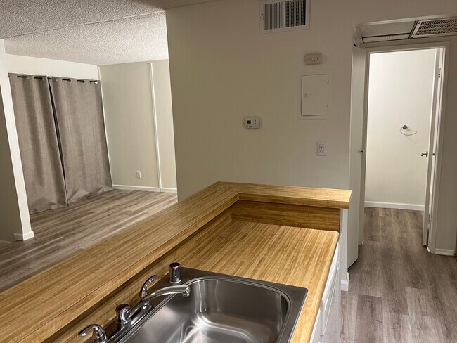 Bedroom, hallway, and bathroom from kitchen - 18645 Hatteras St Unit 109