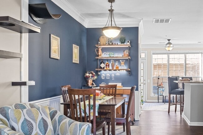Photo - This inviting two-level townhome offers comfort and style, featuring gleaming hardwood floors on ...