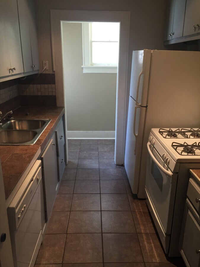 Kitchen with dishwasher, fridge, range, and disposal - 1926 Harold St Apartment