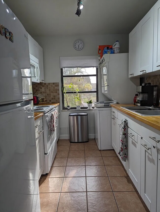 Kitchen includes range, oven, refrigerator/freezer, washer/dryer