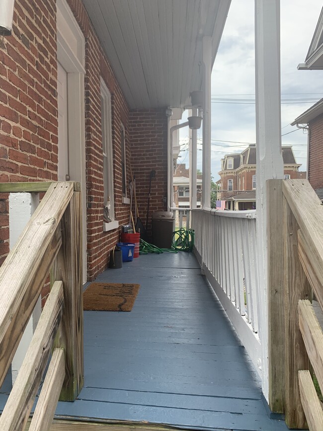 Main entrance. Covered porch. New door/locks. - 321 Lincoln Way W Apartment Unit 2nd Floor