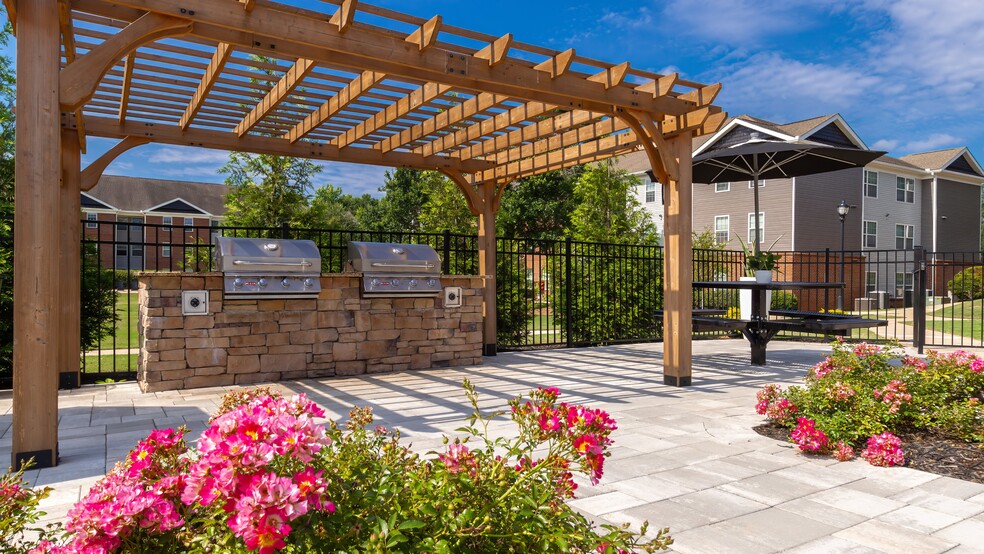 Enjoy beautifully landscaped walkways with wooden pergola shade and colorful flowering plants, professionally operated by Highlands Vista Group
