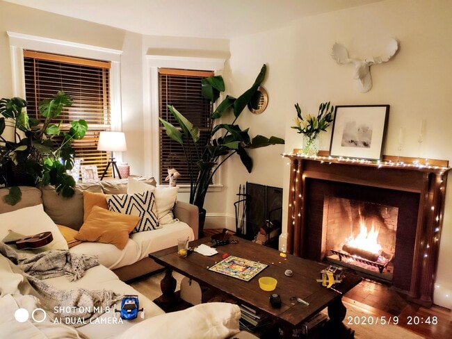 Living room with bay windows and fireplace - 74 Highland Ave Apartments Unit #2