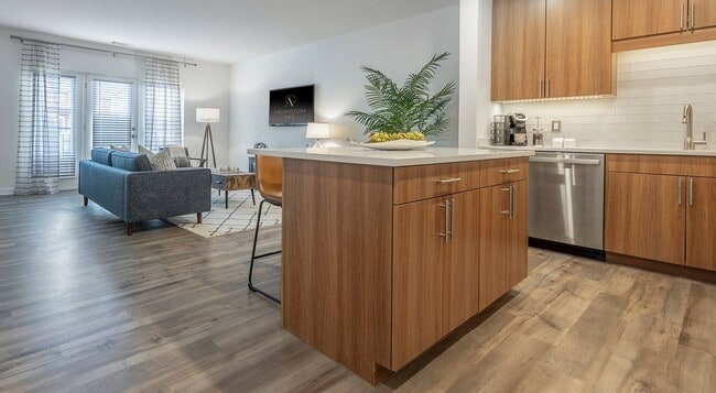 A kitchen island faces the living room, so cooking happens in the same room.