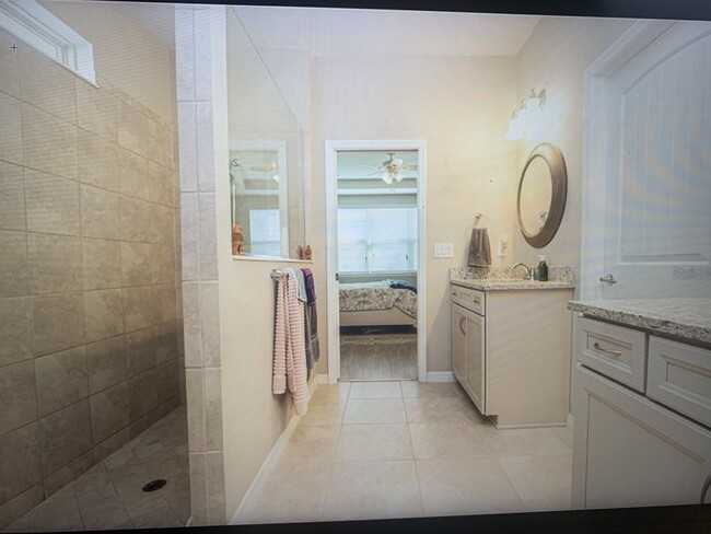 Master bathroom with 2 separate vanities. Rainfall shower and large shower. Toilet is separate - 8012 Olive Brook Dr House