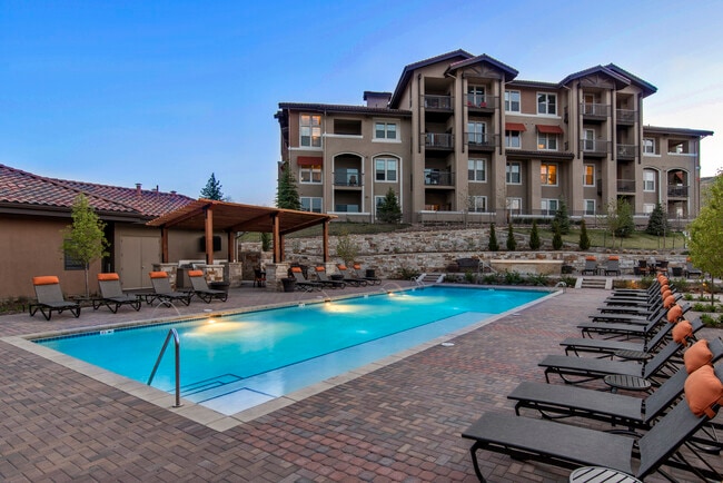 Swimming pool and sundeck with lounge seating - Avalon Denver West Apartments