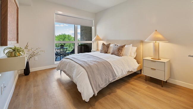 Jade bedroom with large window and neutral tones