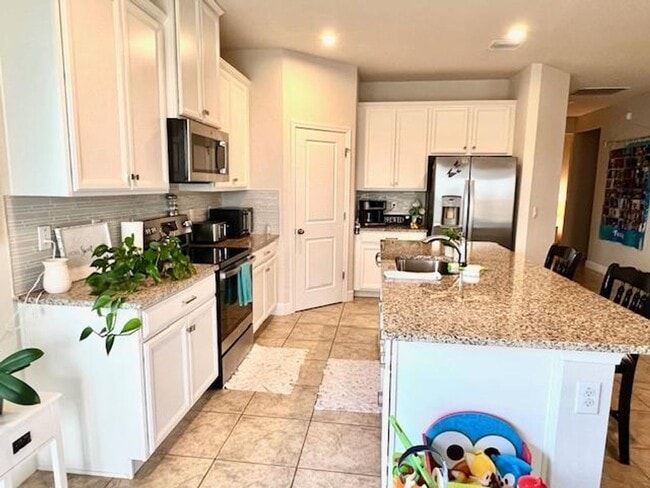 Photo - Open concept home offering four bedrooms, three baths, a two car garage and open lanai.