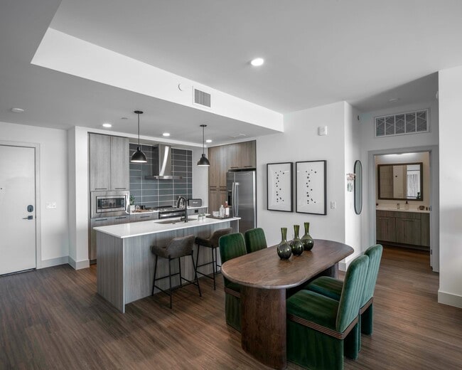 A refined kitchen and dining space that blends natural tones with bold accents. - Mica RiNo Rental
