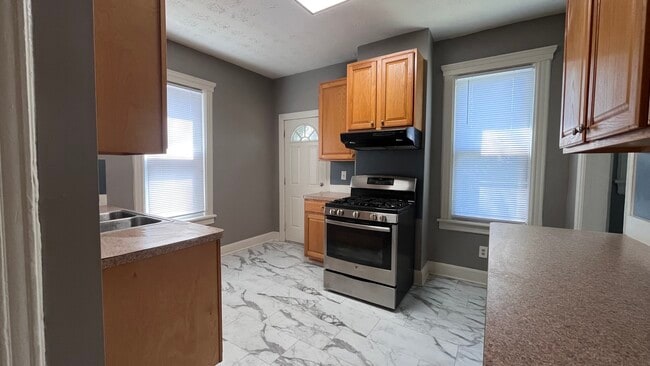 Kitchen with stainless stove - 2366 E 85th St