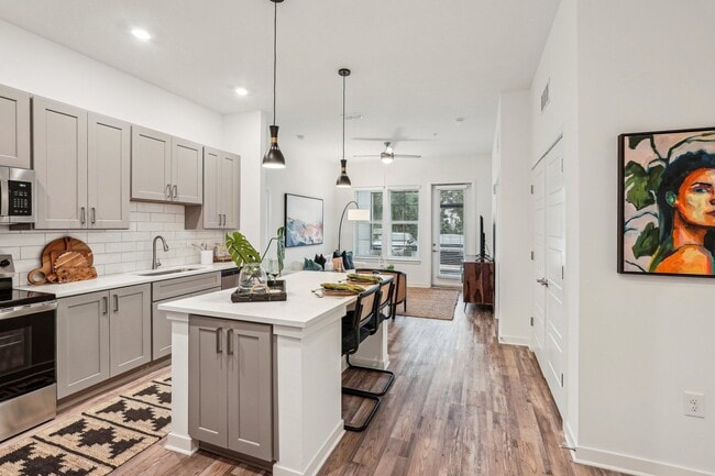 Welcome to your new home. Enjoy you new modern kitchen with a white island and wooden floorsw