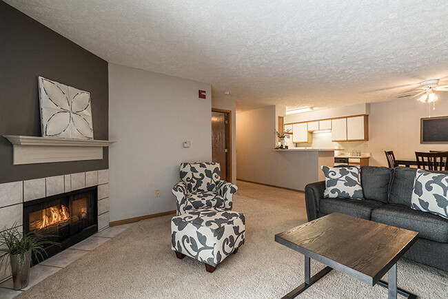 Large living room with fireplace for extra warmth - Eagle Run Apartments