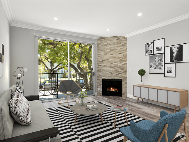 Hardwood floored living room with balcony access and stone walled fireplace. - Clarington Court Rental