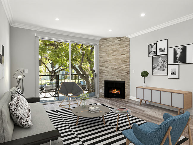 Hardwood floored living room with balcony access and stone walled fireplace. - Clarington Court Apartments