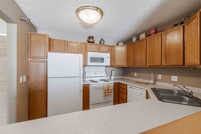 Bright and inviting kitchen featuring elegant wooden cabinetry, modern appliances, and ample countertop space.
