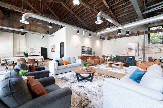 Modern loft-style dining and kitchen area with exposed brick - 1460 Grant