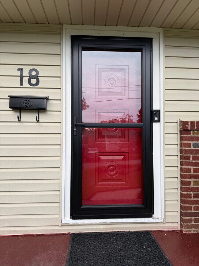 Red Solid Metal Mid Century Modern Entry Door has Heavy Duty Storm Door to provide extra insulation
