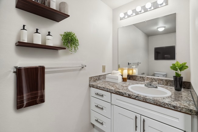 Step into a bathroom retreat featuring a modern vanity and serene ambiance.