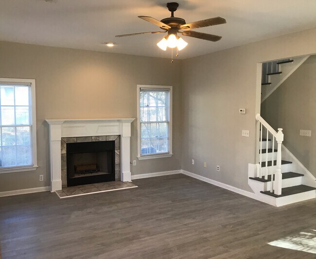 Spacious living room with four window for tons of natural light. - 345 Andrew J Hairston Blvd NW