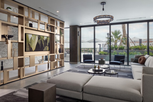 Resident lounge with modern seating and pool deck views