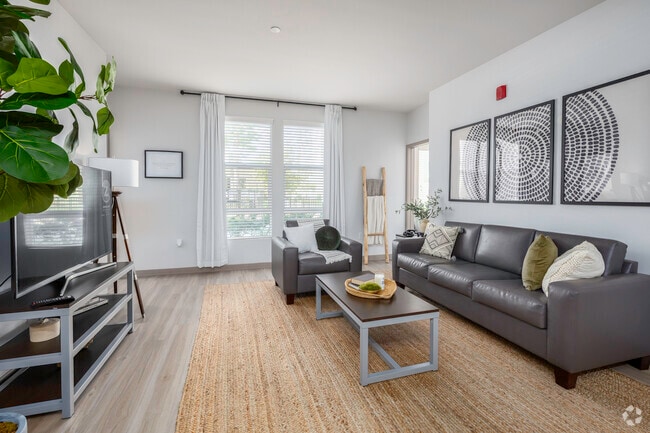 4BR, 4BA - 1395SF - Living Room - The Crossings Student Apartments